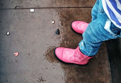 Low section of woman standing on tiled floor