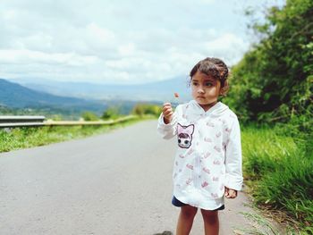 Full length of a girl standing on road