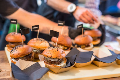 Close-up of hand with food on table