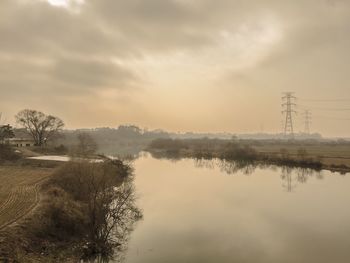 Scenic view of lake against cloudy sky