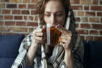 Midsection of woman drinking glass