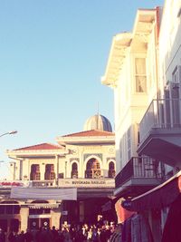 Buildings in city against blue sky