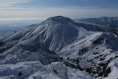 Scenic view of snowcapped mountains against sky