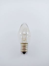 Close-up of light bulb against white background