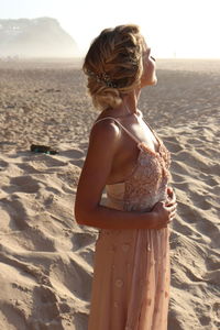 Rear view of woman standing on beach