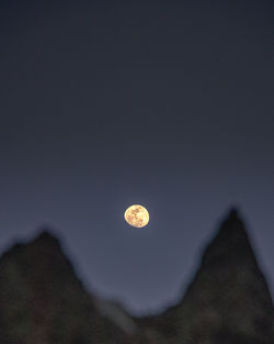 Low angle view of moon against sky at night