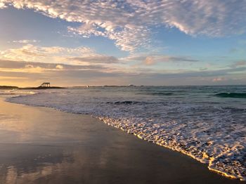 Scenic view of beach against sky during sunset