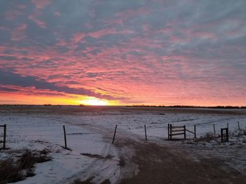 Scenic view of land against sky during sunset