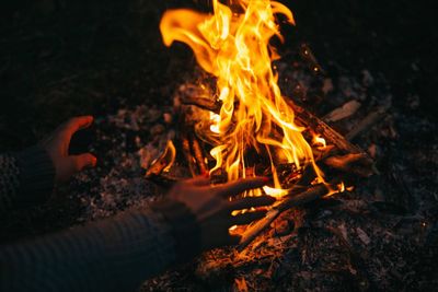 High angle view of man gesturing against campfire