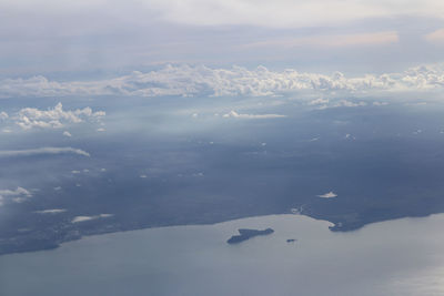 Aerial view of snowcapped mountains against sky