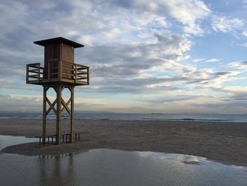 Lifeguard hut at beach against sky