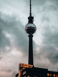 Low angle view of communications tower against sky