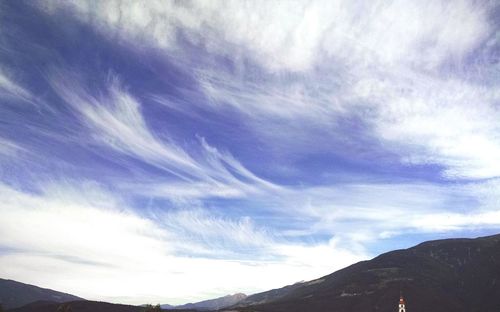 Scenic view of mountains against cloudy sky