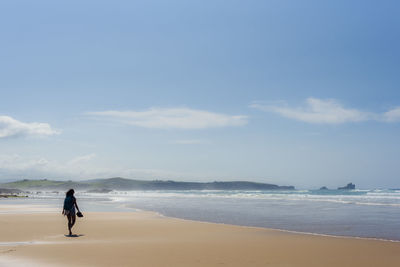 Man on beach against sky