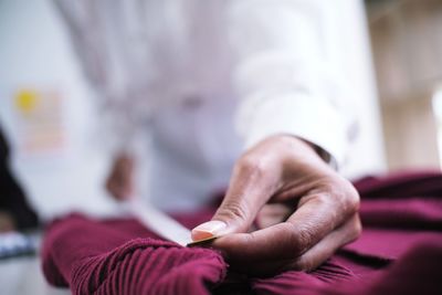 Close-up of fashion designer measuring fabric