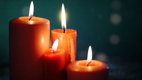 Close-up of lit candle in the dark