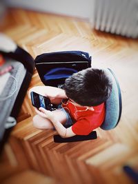 High angle view of boy using mobile phone