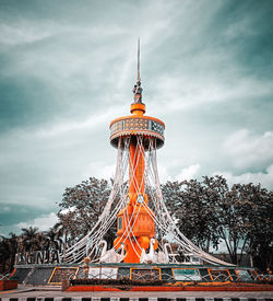 Low angle view of tower and building against sky