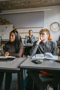 University students sitting at desk in classroom