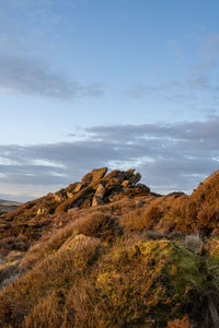 Rock formations on landscape against sky