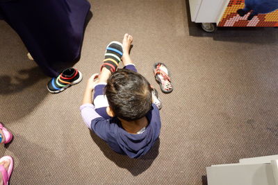 High angle view of men sitting on floor