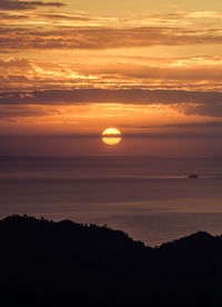Scenic view of sea against romantic sky at sunset