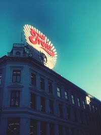 Low angle view of illuminated building against clear sky