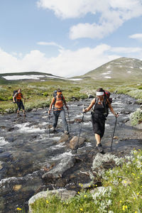 Hikers crossing mountain river