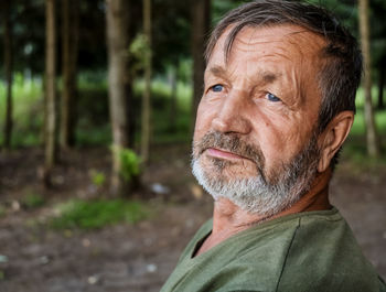 Close-up portrait of man in forest