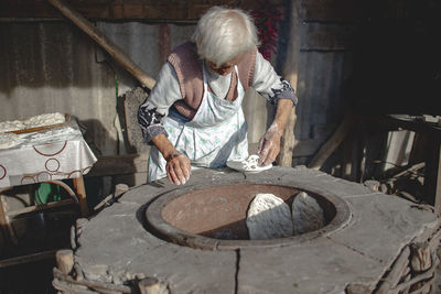 Senior woman working in workshop