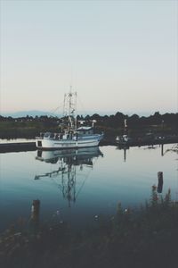 Boats moored at harbor