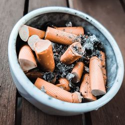 High angle view of cigarette in bowl on table