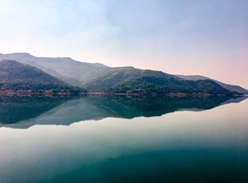 Scenic view of lake and mountains against sky