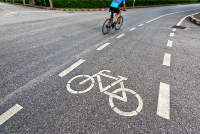 Man riding bicycle on road