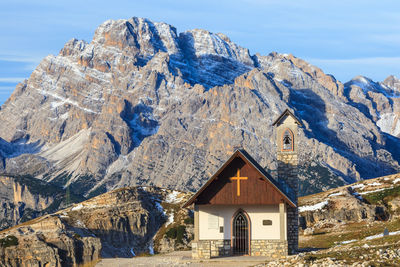 Houses on snow covered mountain against sky