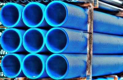 Stacked blue pipes in shelf