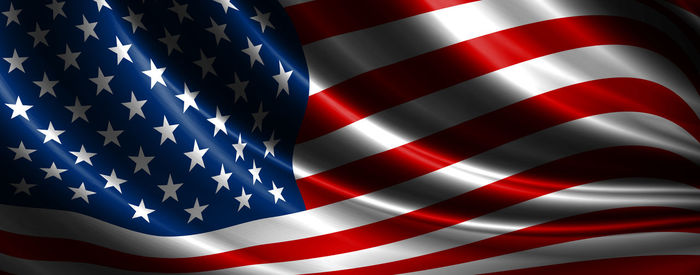 Close-up of flags against blue sky