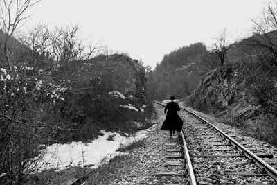 A woman walking on the rails