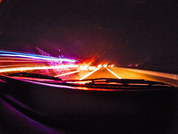 Close-up of light trails on road at night