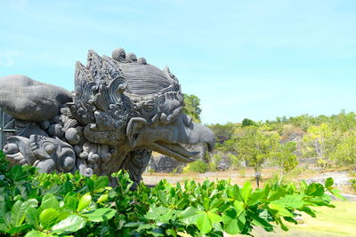 Statue of plants against sky