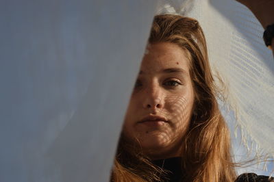 Close-up portrait of young woman with scarf