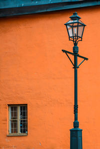 Low angle view of street light against building