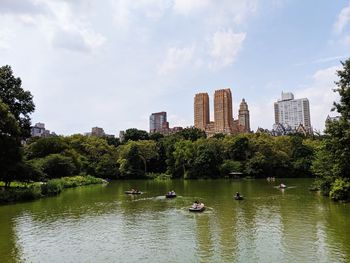 Scenic view of lake by buildings against sky