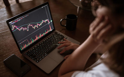 High angle view of woman using laptop on table