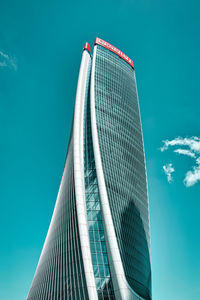 Low angle view of modern building against blue sky