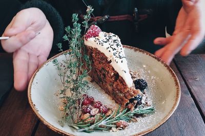 Midsection of person holding ice cream in plate