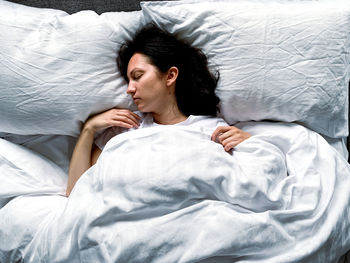 Young woman sleeping on bed