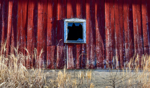 Weathered wood barn wall and window in farm country