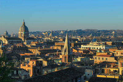 High angle view of buildings in city against clear sky