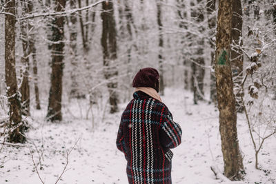 Man standing in forest during winter